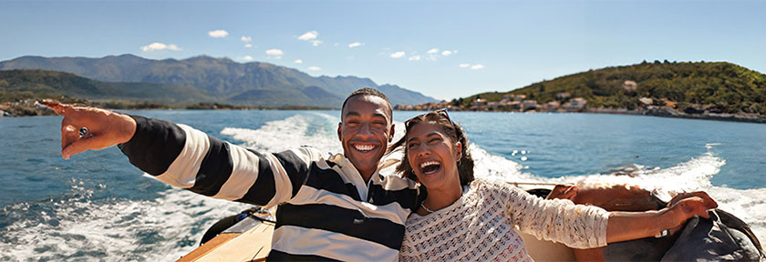 smiling couple on a boat ride on the coast, mobile view, May 2024 blog, TCU,