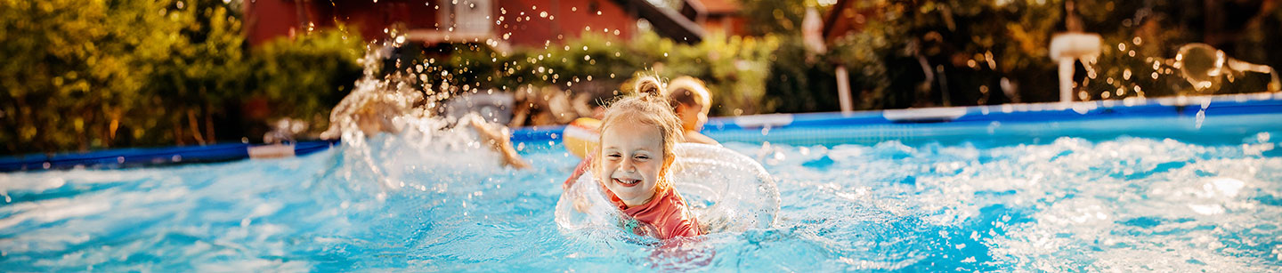 A young child swimming in a backyard pool, May 2024 blog, TCU