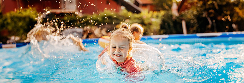 A young child swimming in a backyard pool, mobile view, May 2024 blog, TCU