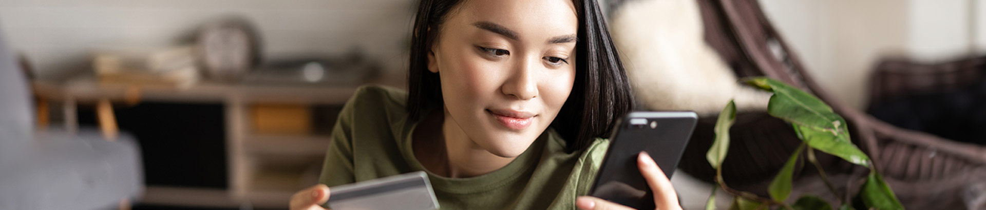 young woman using smartphone for mobile banking, photo banner, Aug2023 blog, Travis CU,