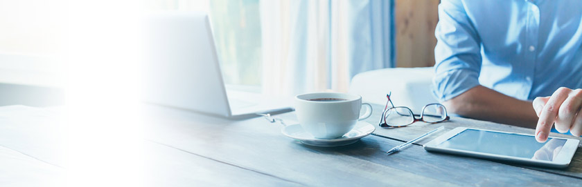 In the News category, person at desk using tablet tapping screen, mobile banner,