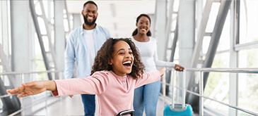 Smiling parents and child on vacation with suitcases at airport, mobile view
