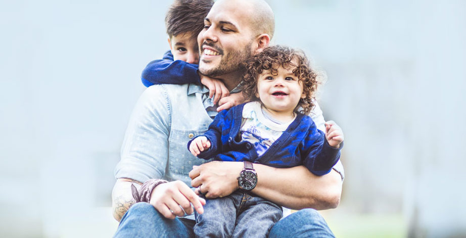 Dad playing outside with kids, Keeping You Secure Photo