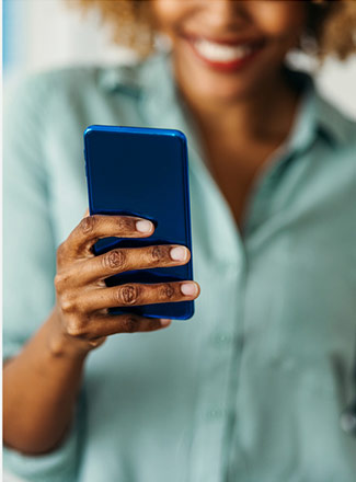 photo of smiling woman holding smartphone