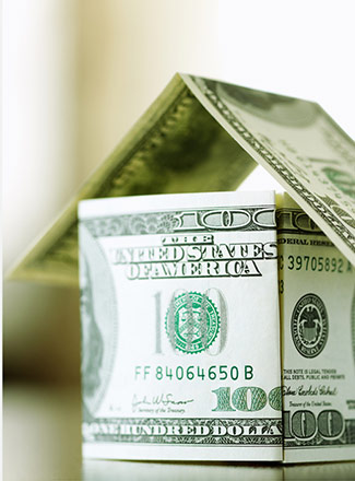 photo of cash bills folded into shape of a house